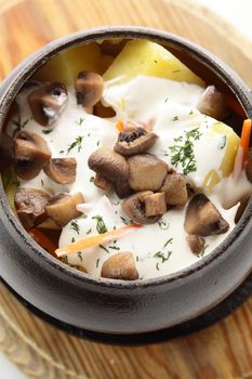 hot roasted meat with pancake and mushrooms on wooden desk