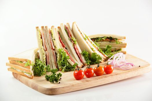 fresh sandwiches on wooden desk and white background