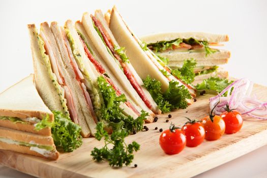 fresh sandwiches on wooden desk and white background
