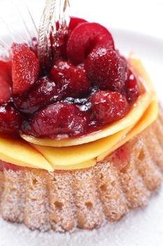 tasty and sweet cake on dish and white background