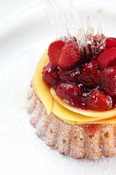 tasty and sweet cake on dish and white background