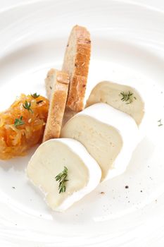 tasty peaces of cheese on white dish with garnish