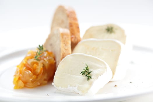 tasty peaces of cheese on white dish with garnish