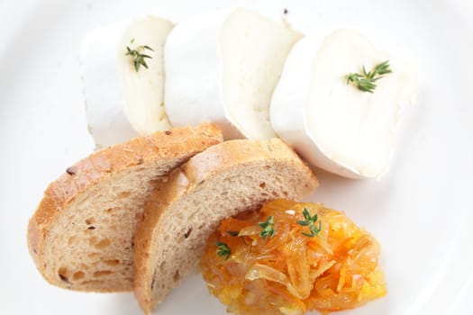 tasty peaces of cheese on white dish with garnish