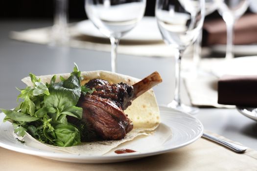 hot peace of meat on white dish and grey table