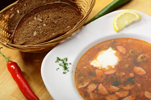 tasty and hot soup with sausages and lemon