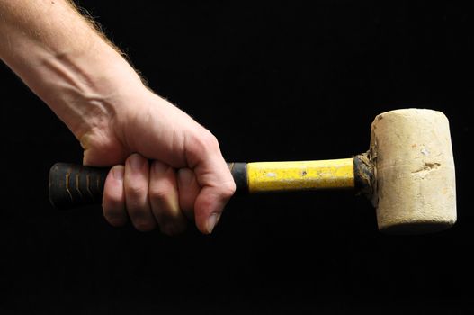 Hammer and a Hand on a Black Background