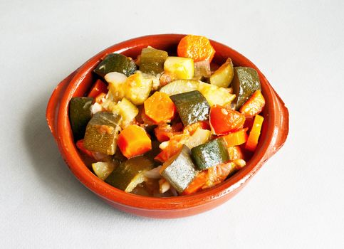 Stuffed vegetables in ceramic bowl over gray background