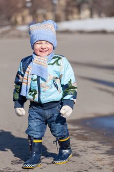 Little boy in rubber boots