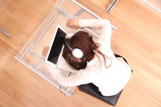 A woman sleeping on the Laptop.