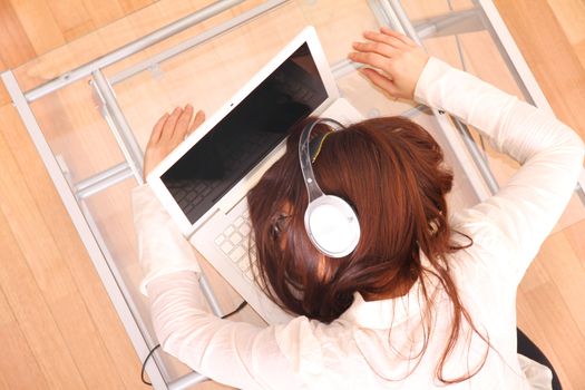 A woman sleeping on the Laptop.