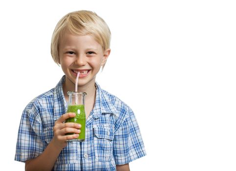 A cute young healthy boy drinking a green smoothie or jucie through a straw. Isolated on white.