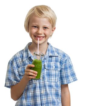 A cute young healthy boy drinking a green smoothie or jucie. Isolated on white.