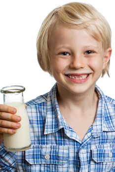 Close-up of a happy cute boy with milk moustache and bottle of milk. Isolated on white.