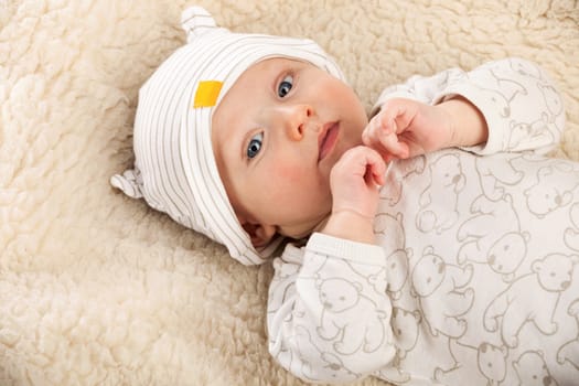 Closeup portrait of baby boyis a sheep-blanket