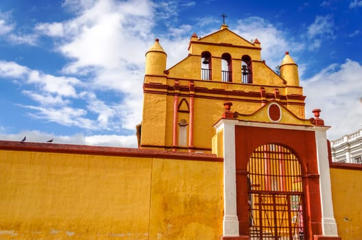 Yellow and red colonial style church in the town of San Cristobal de las Casas in Chiapas, Mexico