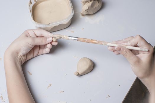 Girl make toyfrom clay. High resolution image.