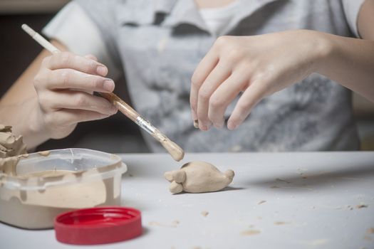 Girl make toyfrom clay. High resolution image.