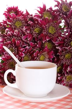 cup of tea and chrysanthemums on old wooden boards