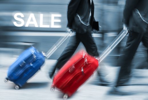 Sale. People with suitcases in a hurry. Intentional motion blur and color shift