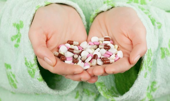 Closeup view of many pills in cupped hands