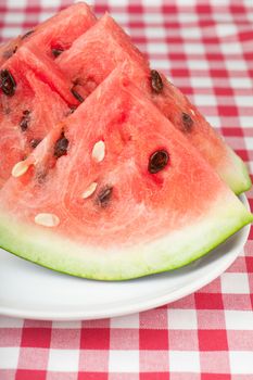 Fresh watermelon slices on a white plate