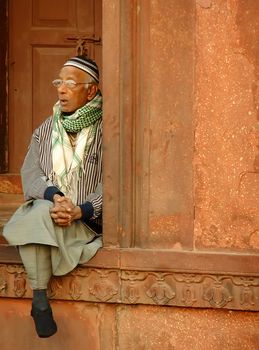 Indian man sitting at Jama Masjid, Delhi, India