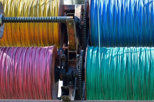 Industrial size spools of colorful ropes used in utility and power work