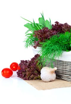 green herbs in braided basket isolated on white background