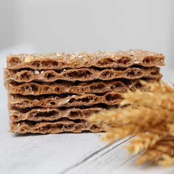 Low angle view of a stack of wheat crackers or crispbread showing the texture of the crisp hard biscuits served as an accompaniment to a meal or cheese