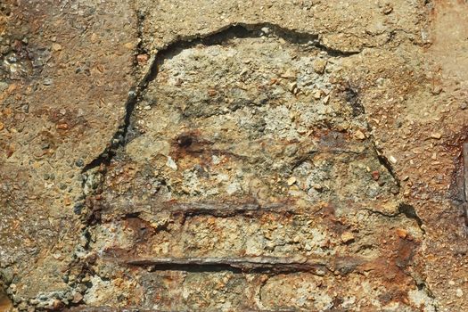 Detail of old broken concrete blocks with rusty iron rods outside