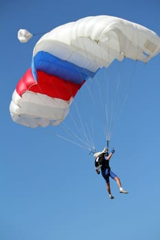 extreme sport parachutist on blue sky 