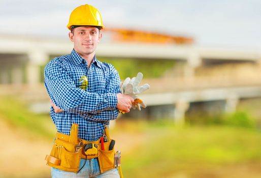 a young contractor with tools on construction site