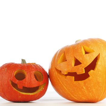 Two funny Halloween pumpkins on white background