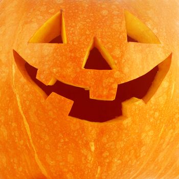 Funny carved Halloween pumpkin background close-up