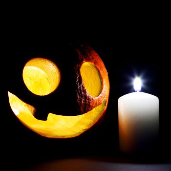 Halloween pumpkins with candles on black background