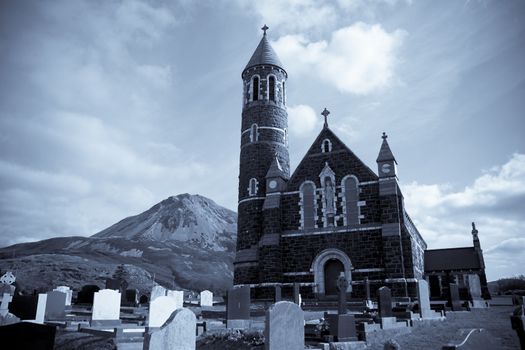 Church of the Sacred Heart, Dunlewey with Errigal mountains in Donegal Ireland blue toned