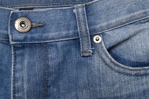 Close up image of denim jeans pocket with a ripped hole