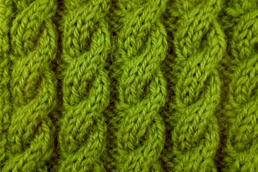 Closeup of green coiled rope cable knitting stitch