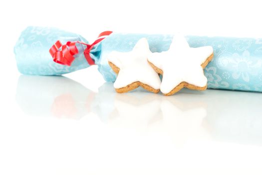 Blue gift with star shaped cinnamon biscuit