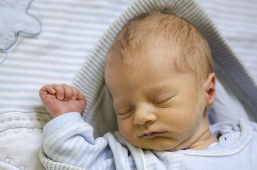 Face of a ute baby sleeping on its back and dreaming