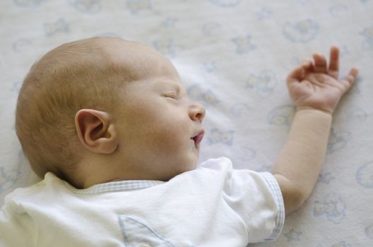 Face of a ute baby sleeping on its back and dreaming