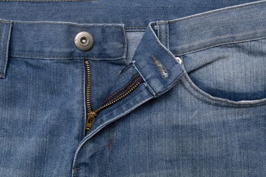 Close up image of denim jeans pocket with a ripped hole