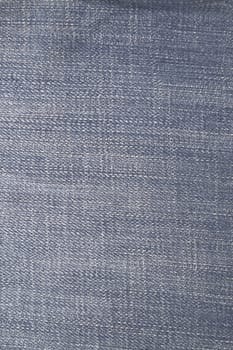 Close up image of denim jeans pocket with a ripped hole