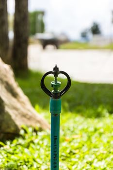 sprinkler water on gardens background