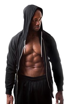 Toned and ripped lean muscle fitness man wearing a hooded sweatshirt isolated over a white background.