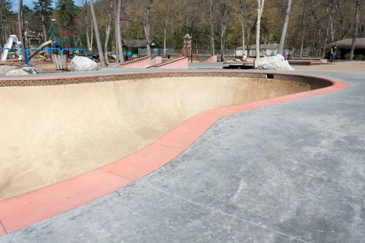 Close up detail of an empty skate park bowl ramp.