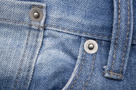 Close up image of denim jeans pocket with a ripped hole