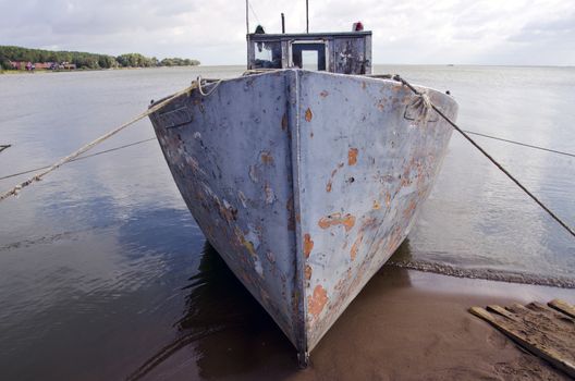 old fishing boat near coast in sea