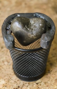 The Metal forged heart and horseshoe on a cork background